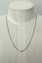 Necklace with scattered stamped silver beads on silk thread