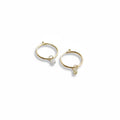 "Pair of 14K yellow gold 12mm endless hoop earrings with .20 carat diamond bead drops, styled on a dark textured background"