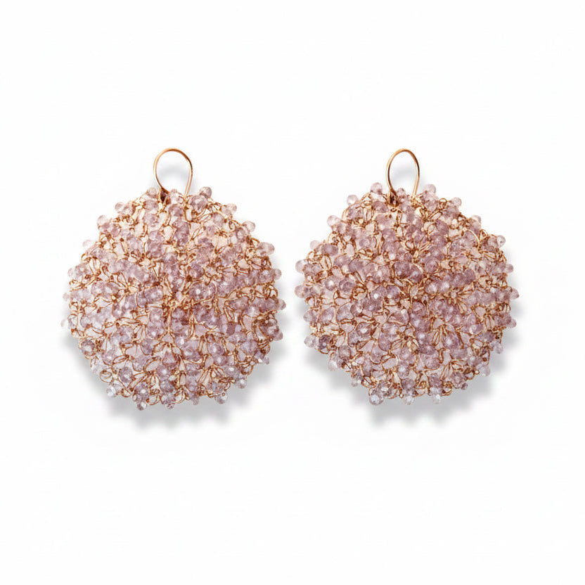 A pair of rose gold-colored earrings with purple amethyst beads, crocheted with 14k rose gold wire.