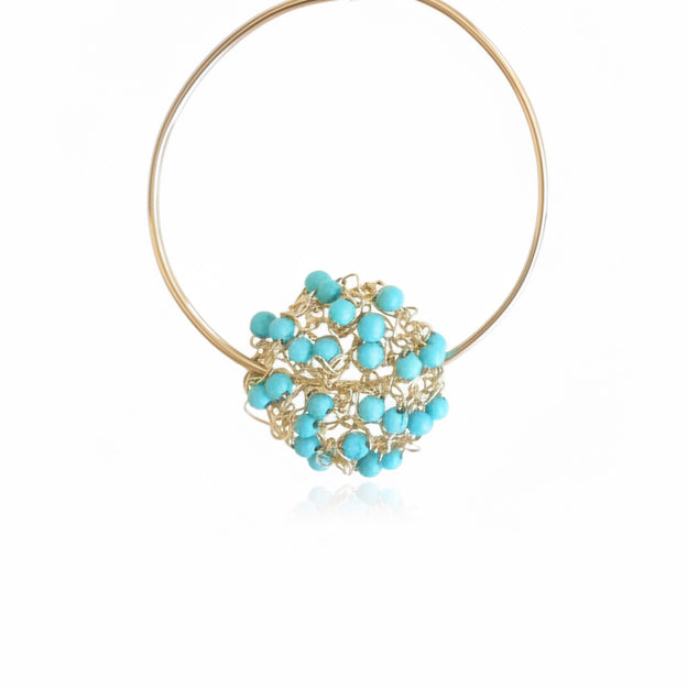 Gold hoop earring with turquoise beads on a white background